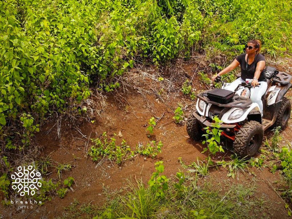 Davina surveys the land on an ATV